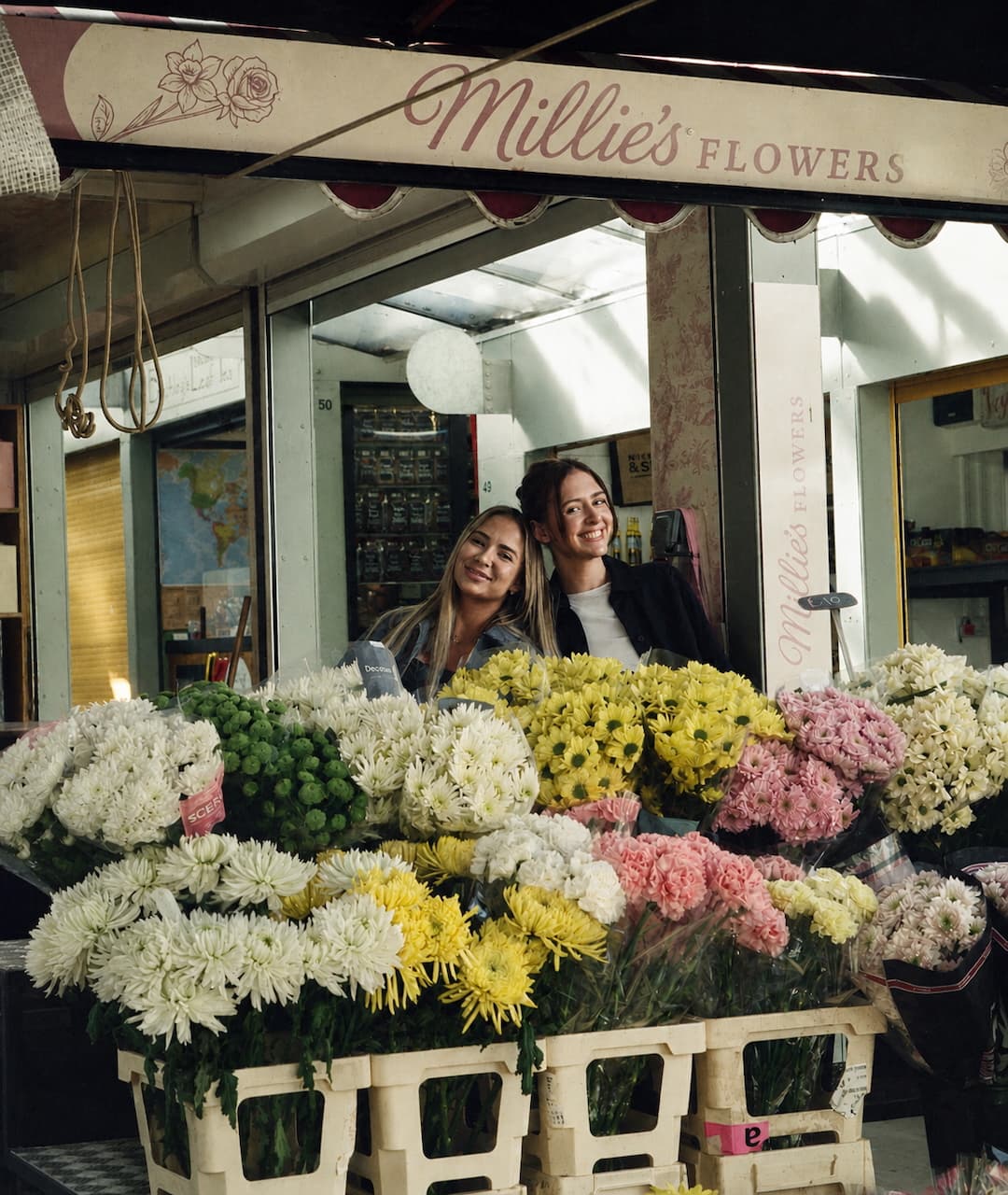Two florists at Millie's Flowers stall full of fresh flowers