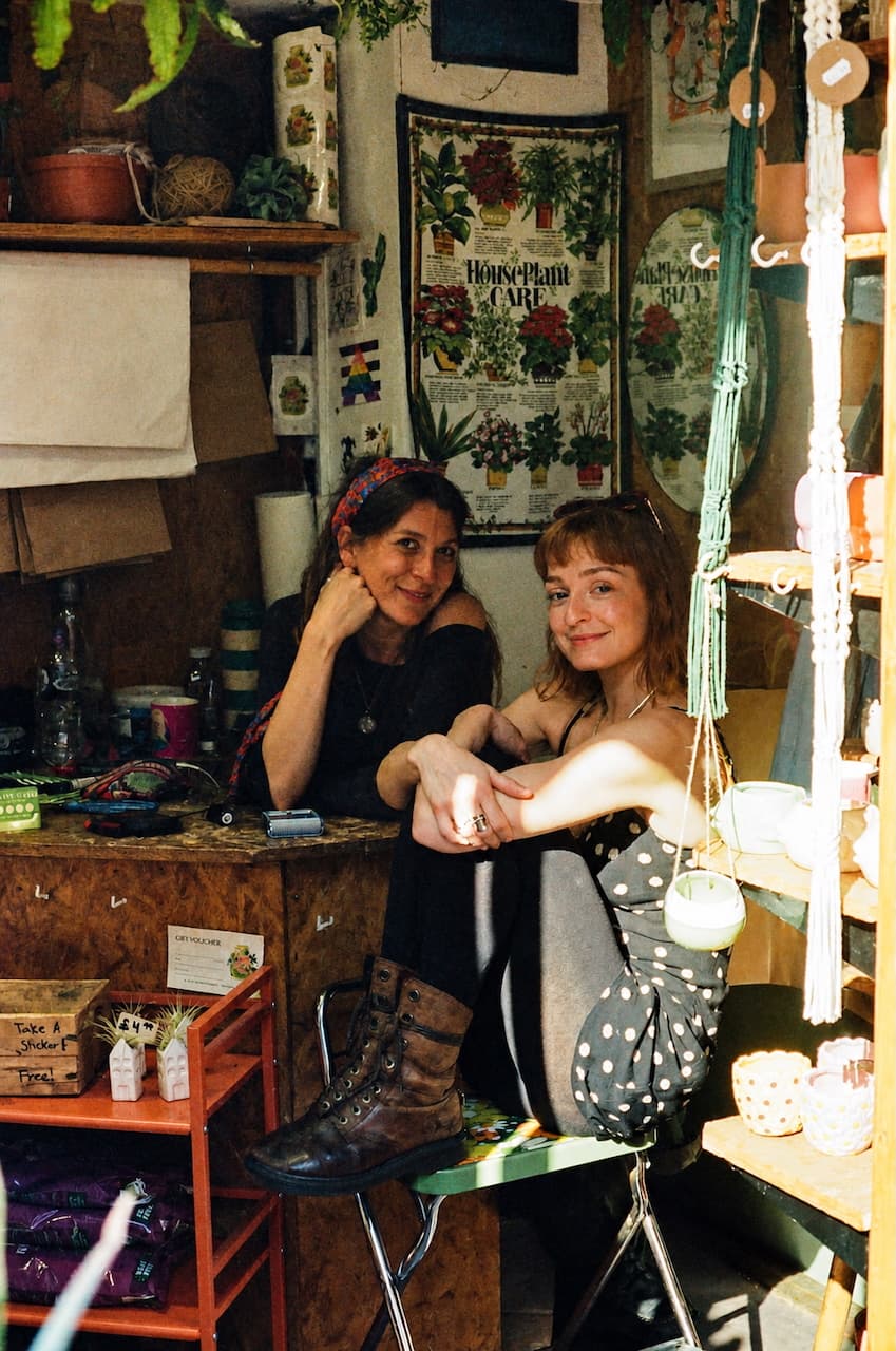 Two women in a craft and houseplant stall