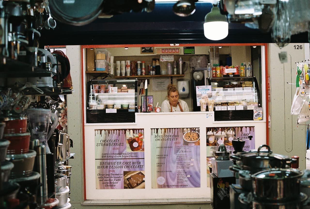 Chocolate stall in Norwich Market with menu signs