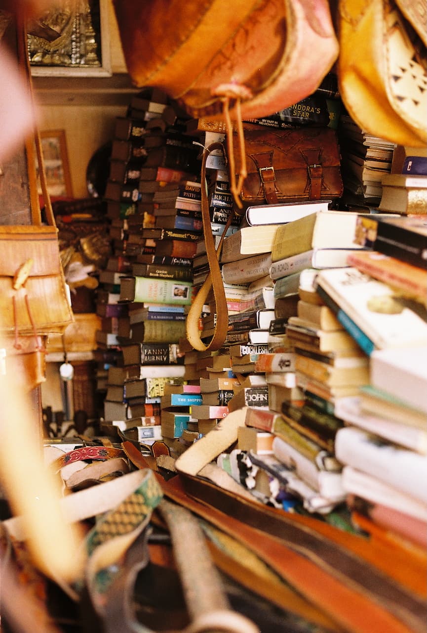 Towers of second-hand books and hanging leather bags